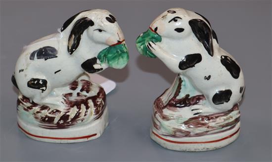 A pair of Staffordshire black and white pottery rabbits